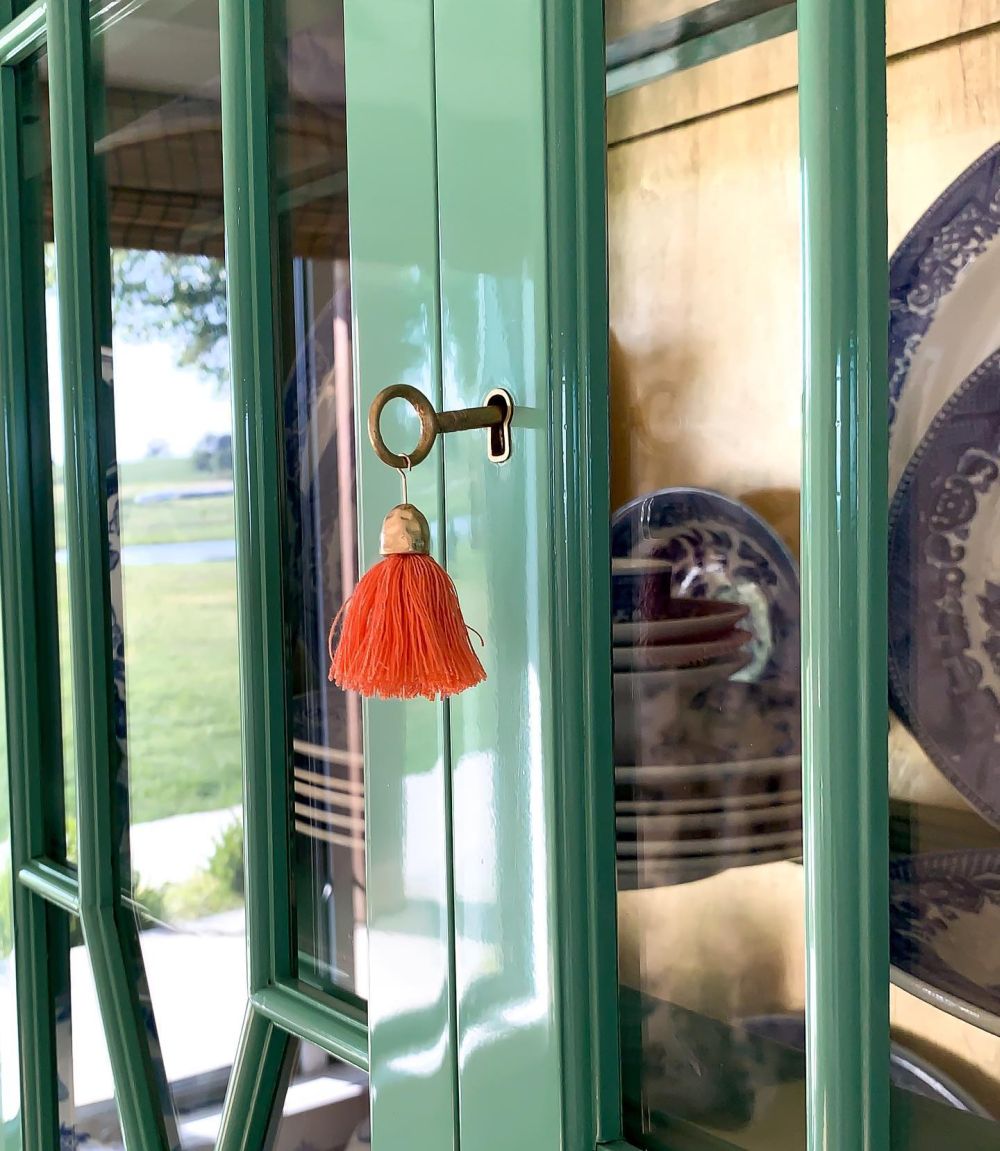 An orange tassel hangs from the cabinet key