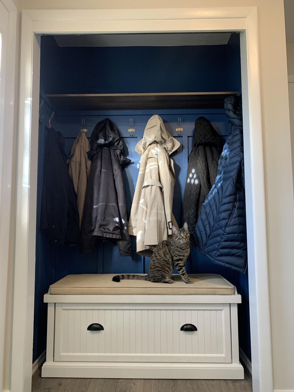 An overhead shelf restored storage above the coats