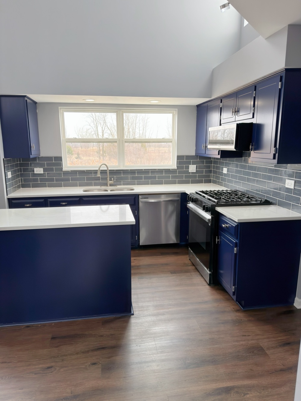 He Painted the White Kitchen Cabinets a Bold Blue and the Whole Kitchen Took on a Custom-Built Look