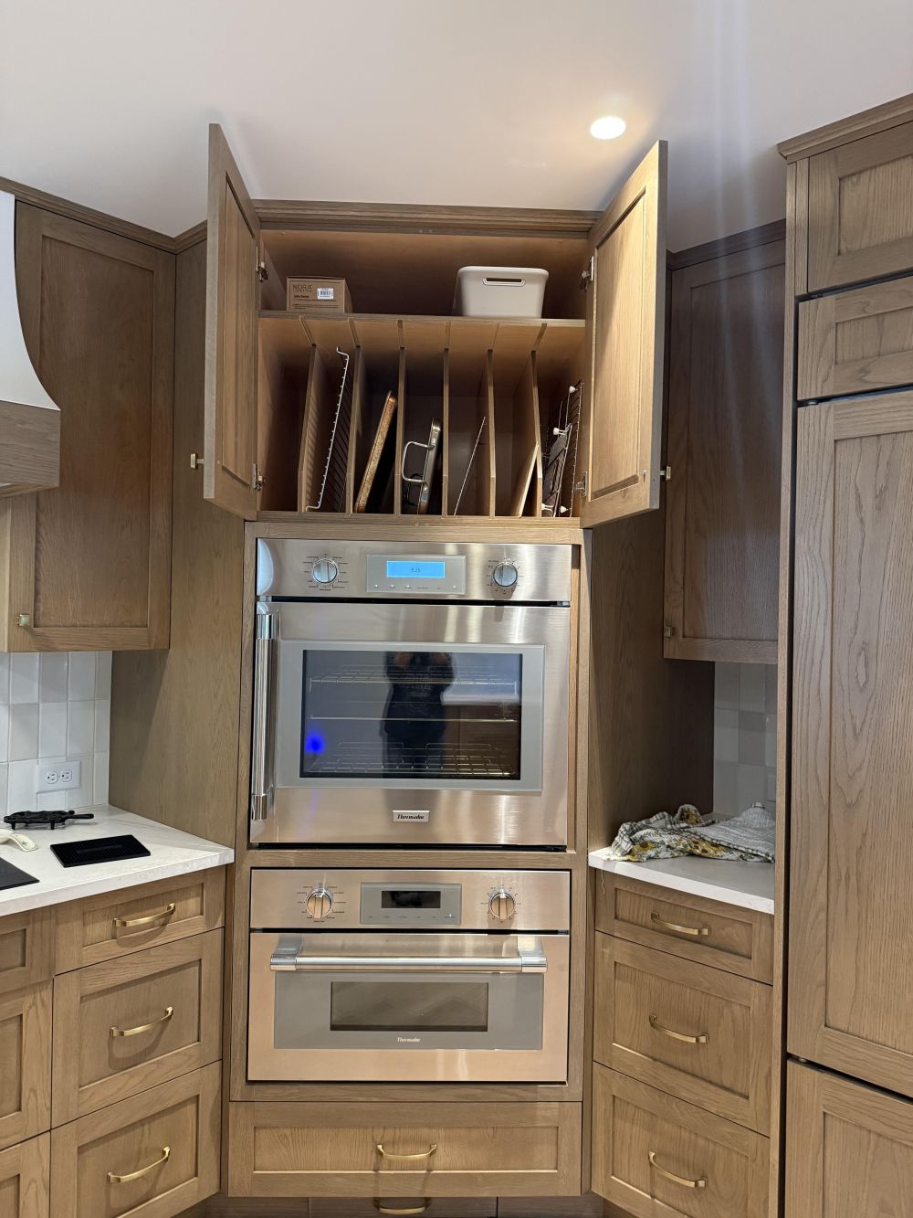 Baking Sheets Have Their Own Cabinet Above the Oven