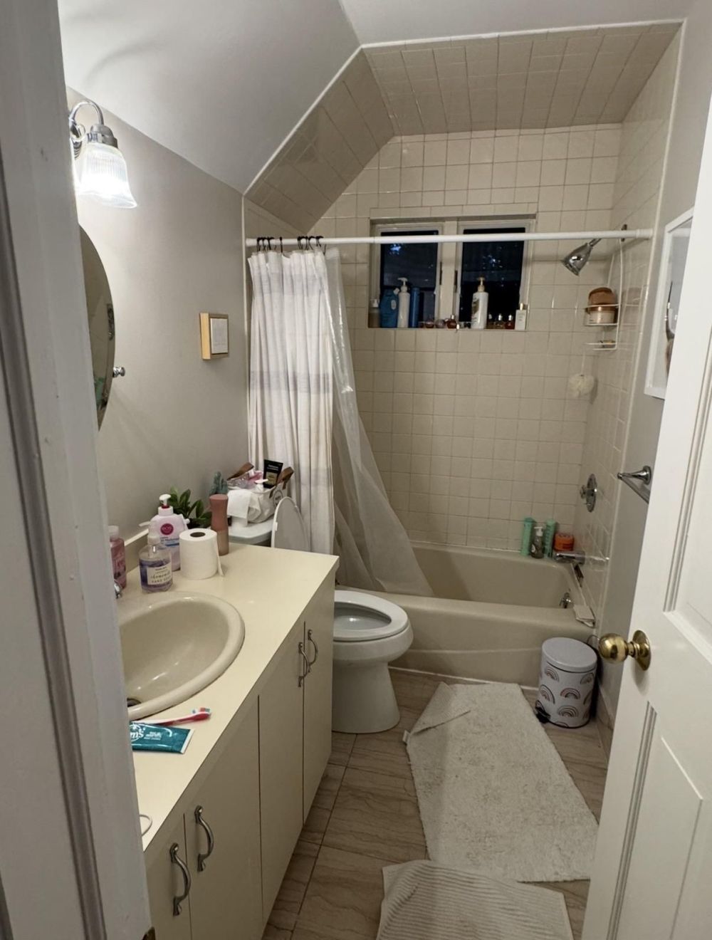 Before A Bathtub, Shower Curtain, and Builder-Grade Vanity