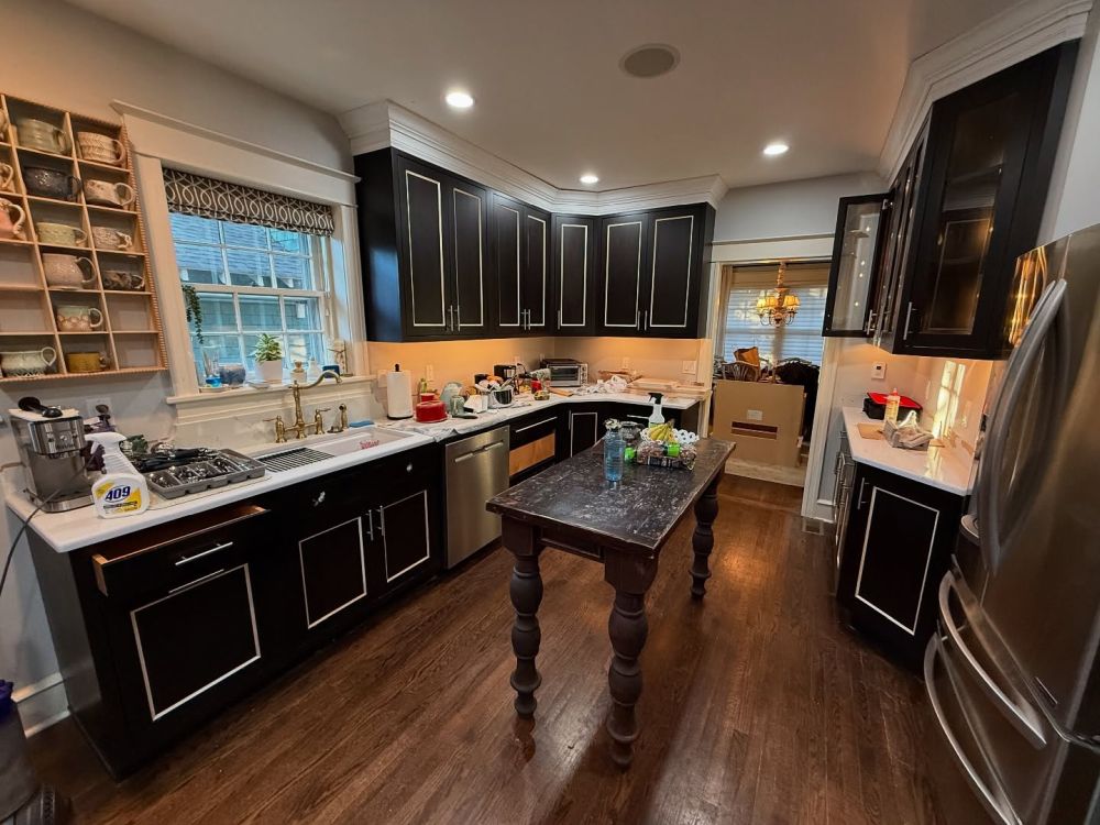 Black Cabinets With White Outlines Filled the Original Kitchen