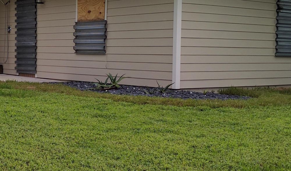 Black Gravel Covered the Narrow Bed Beside the House