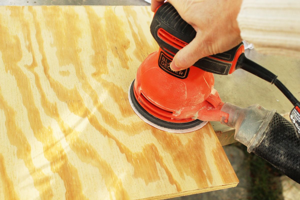 Brittney sanded the plywood surface