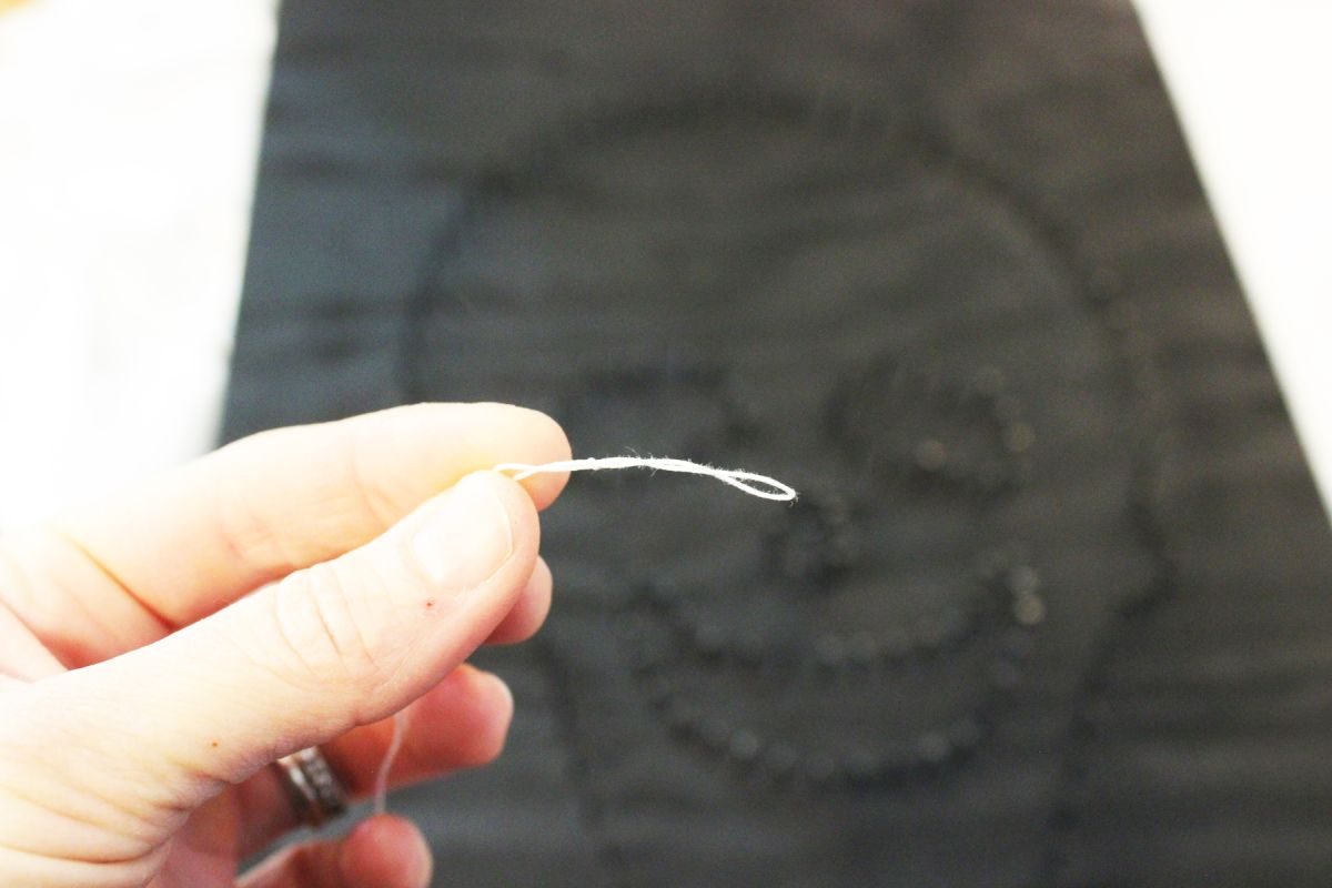 Brittney tied a loop at the end of the string and hooked