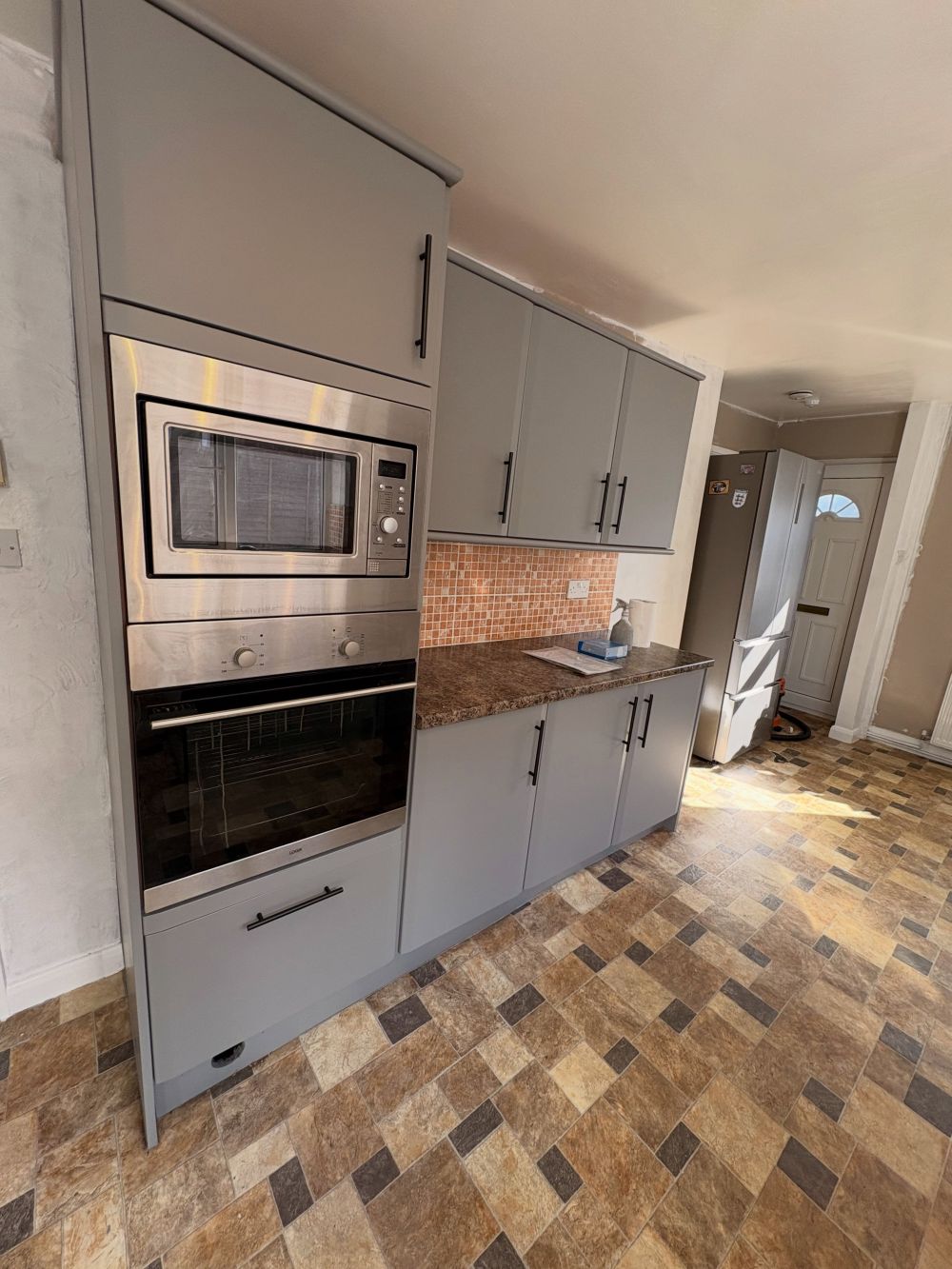Brown Countertops and Peach Tiles Stayed in Place