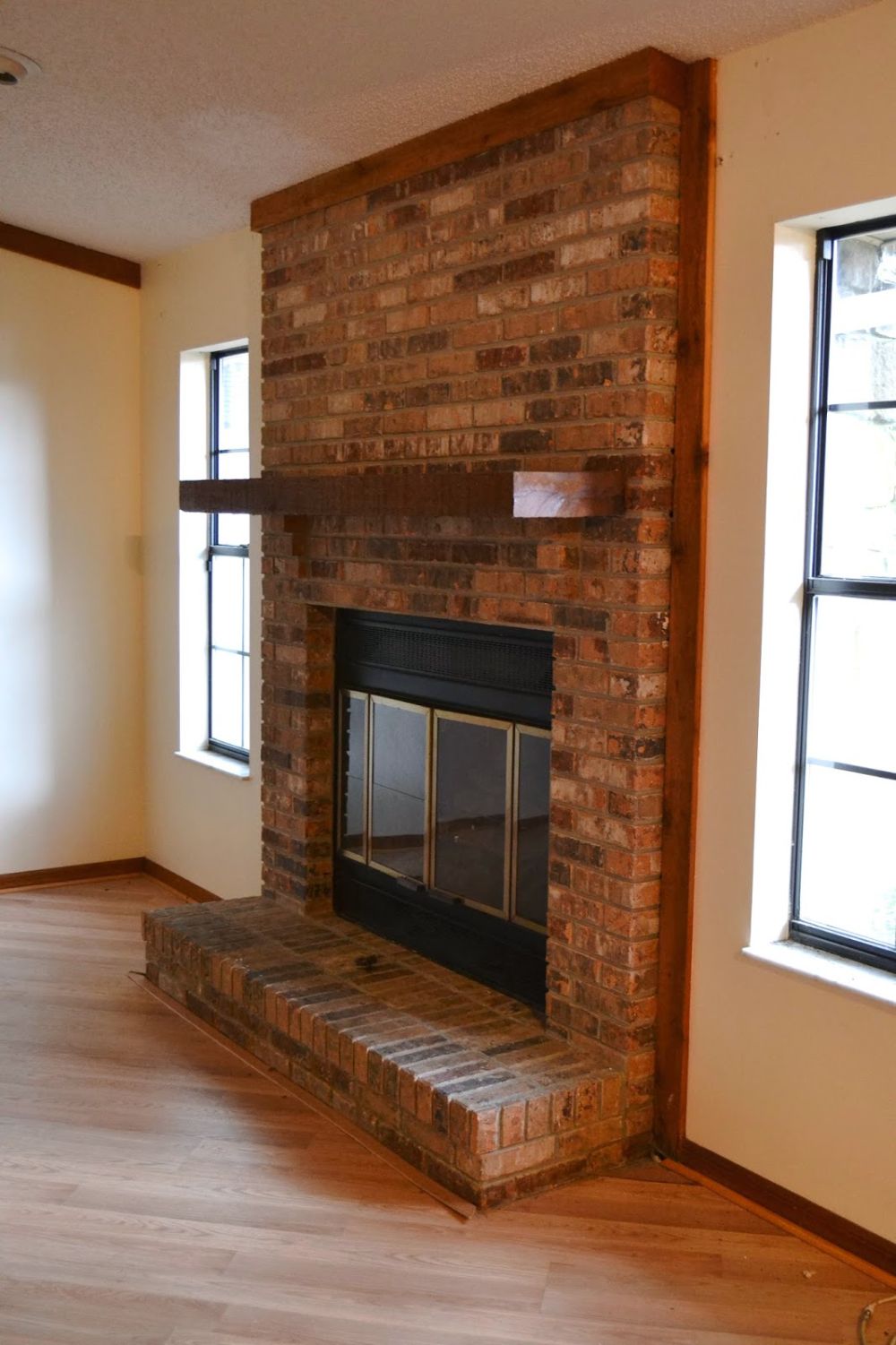 Brown Wood Framed the Brick From Hearth to Ceiling