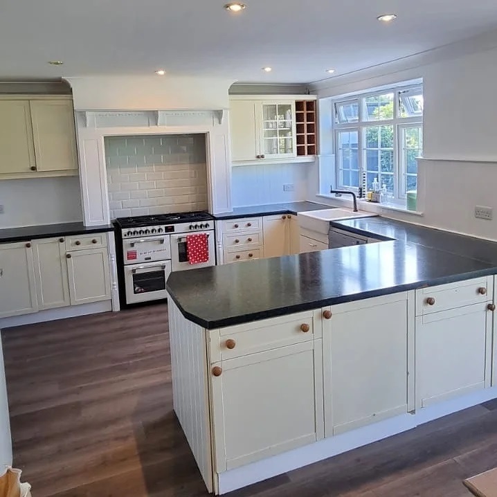 Cream cabinets filled almost every side of the kitchen