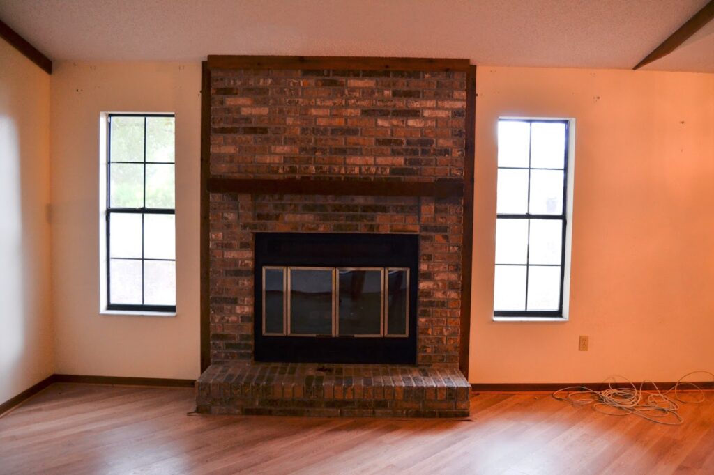 Dark Brick Filled the Wall Between Two Windows