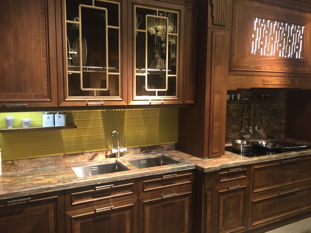Dark wood cabinets feature geometric gold-toned