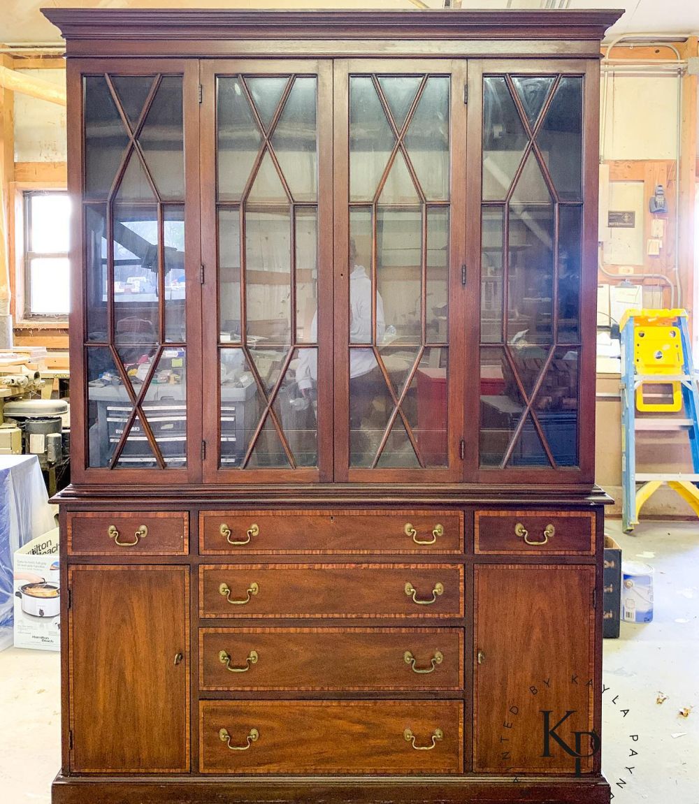 Dark wood covered the cabinet from cornice to base