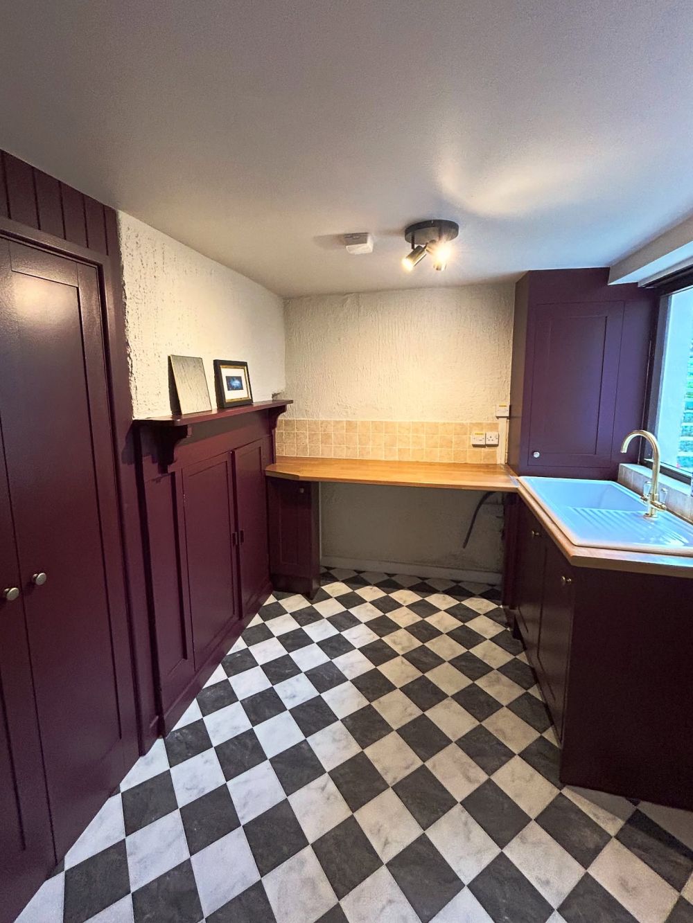 Deep plum connected storage on both sides of the room
