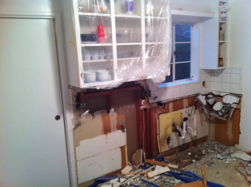 Demolition exposed the plumbing behind the sink wall