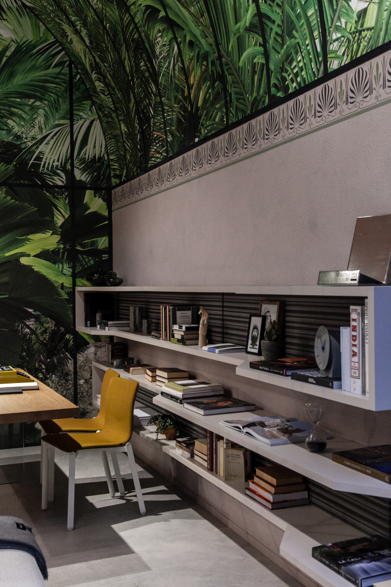 Floating white shelves give a workspace room to breathe