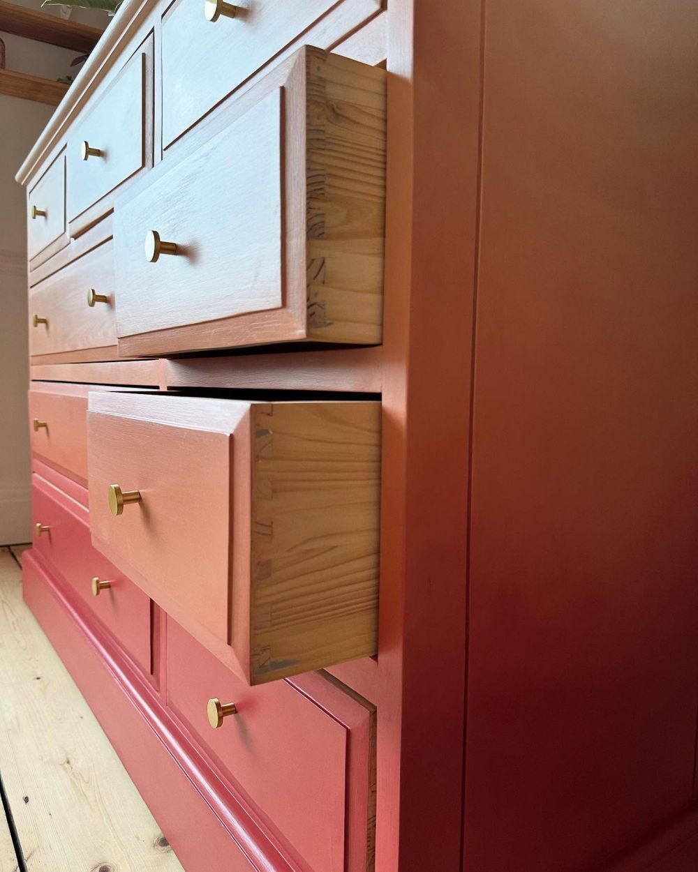 Gold-toned knobs punctuate the changing colors