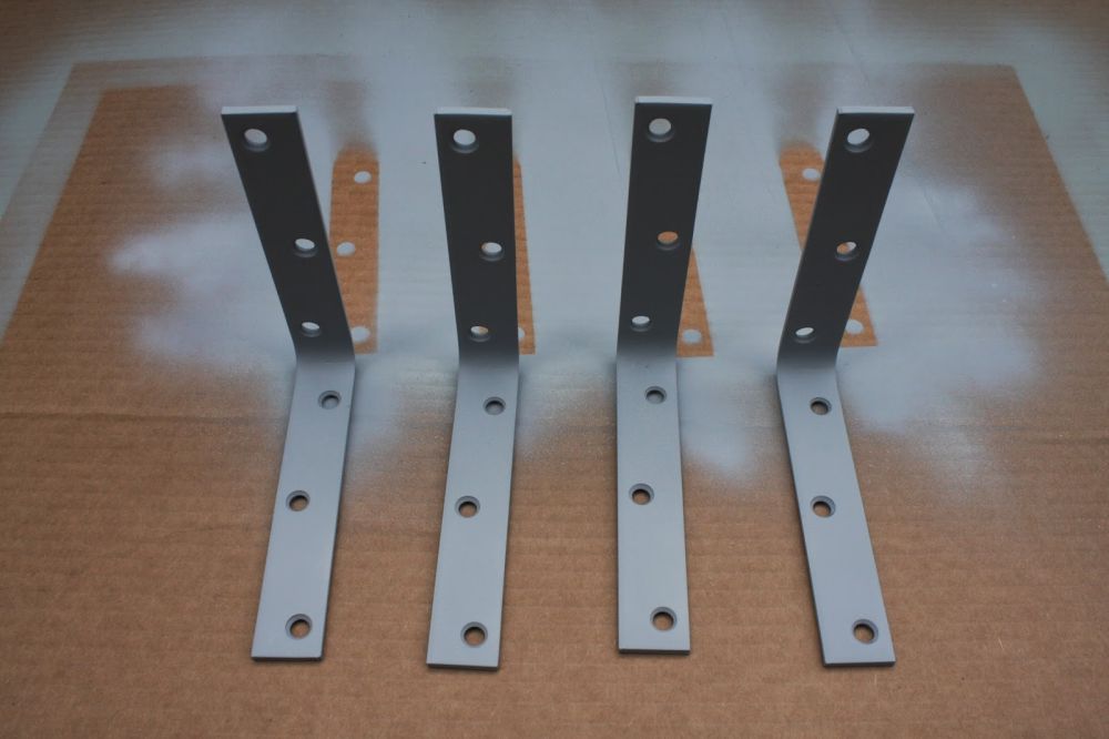 Leftover gray paint finished four metal brackets