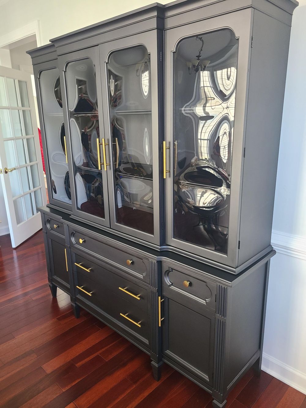 Long vertical gold handles replace the shorter