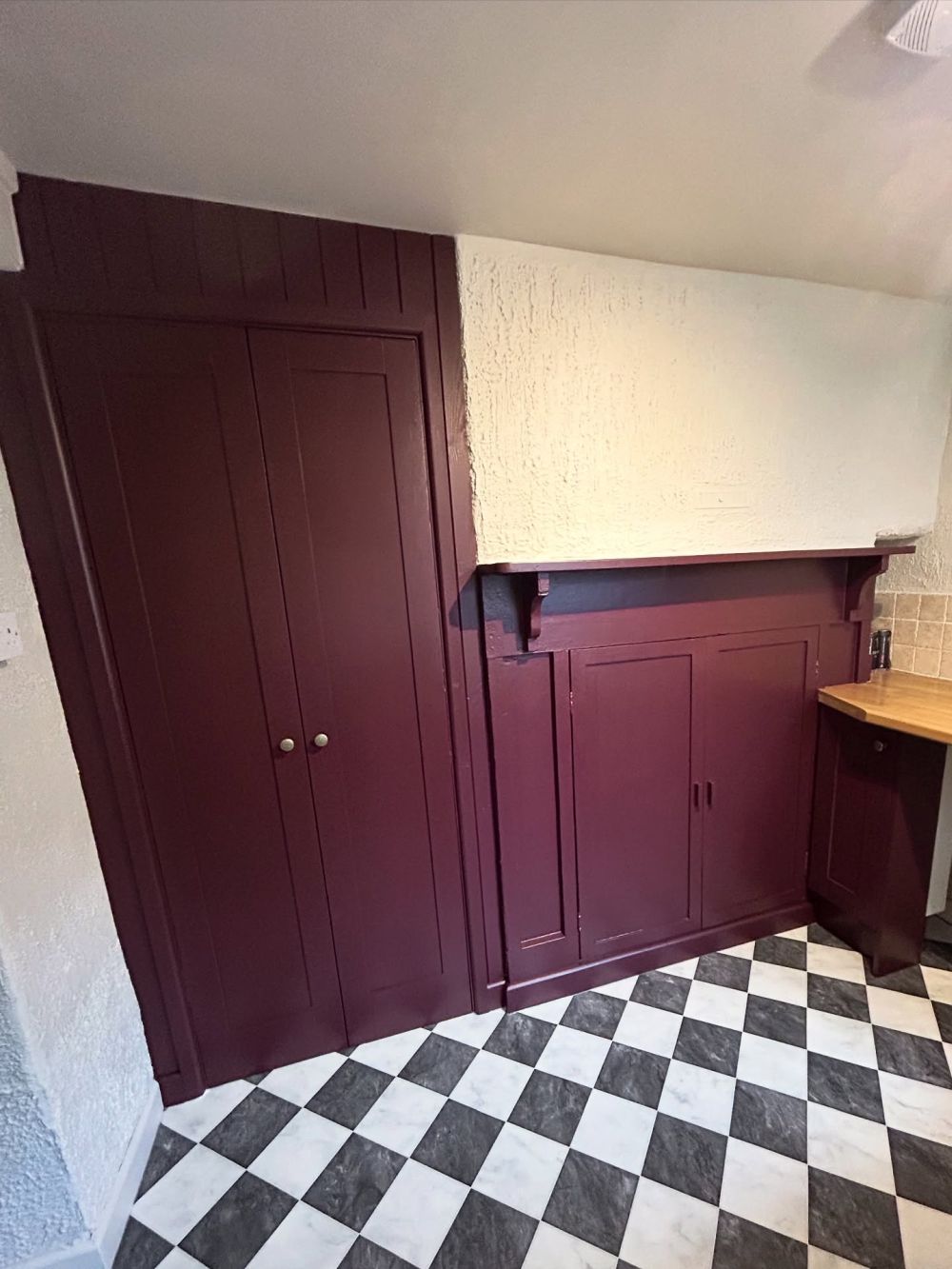 Matching paint brings the fireplace surround into the cabinet scheme