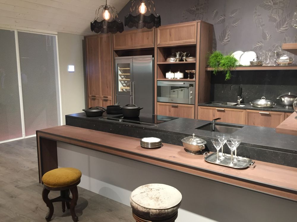 Medium-brown cabinets surround a built-in refrigerator and oven