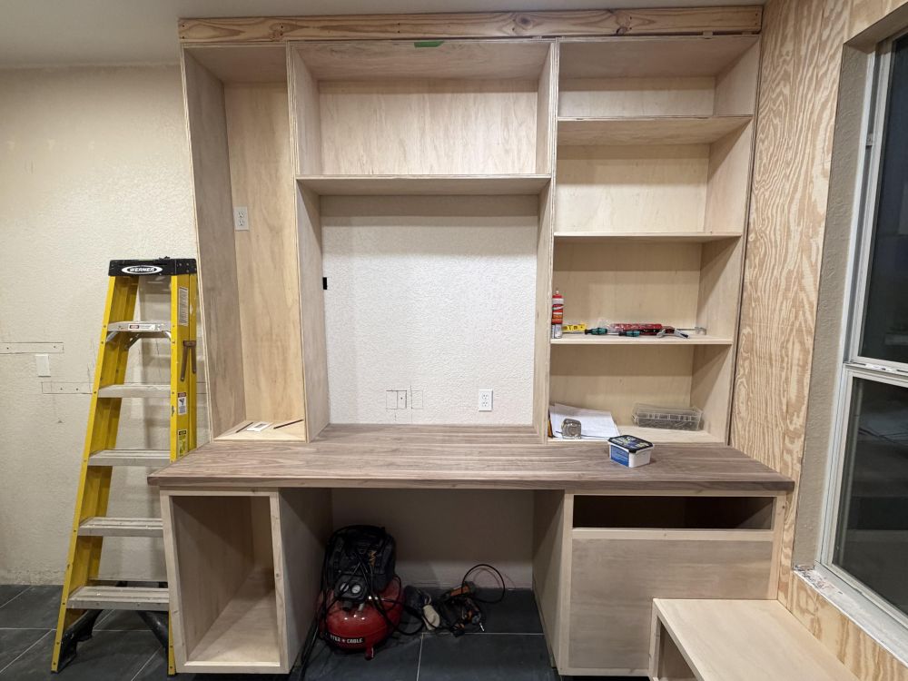 One Wall Became a Workstation With Storage Above and Below