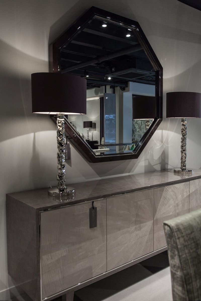 Paired Lamps Frame a Mirror With Light and Shadow