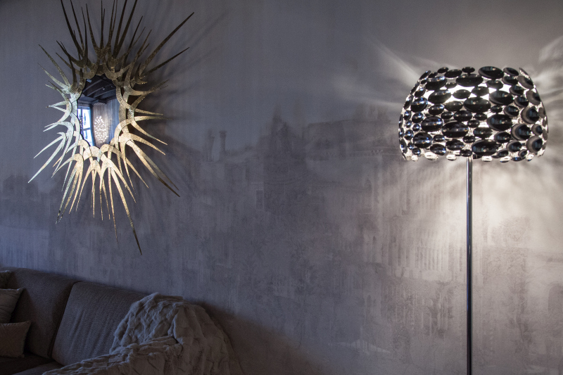 Reflective Pieces Break Up the Light Around a Floor Lamp