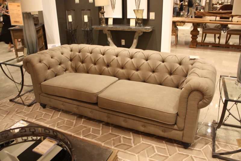 Rolled arms and deep buttons give beige upholstery a traditional profile