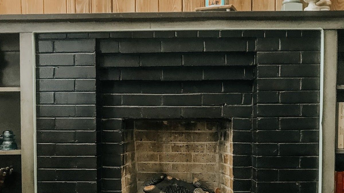 She Had a Black Brick Fireplace but Wanted It White, So She Grabbed Leftover Paint From the Shed