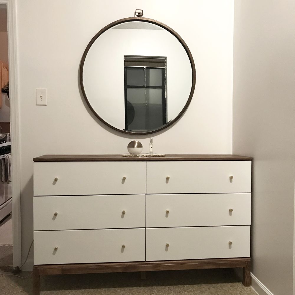 The Dresser Found Its Place Beneath a Round Mirror