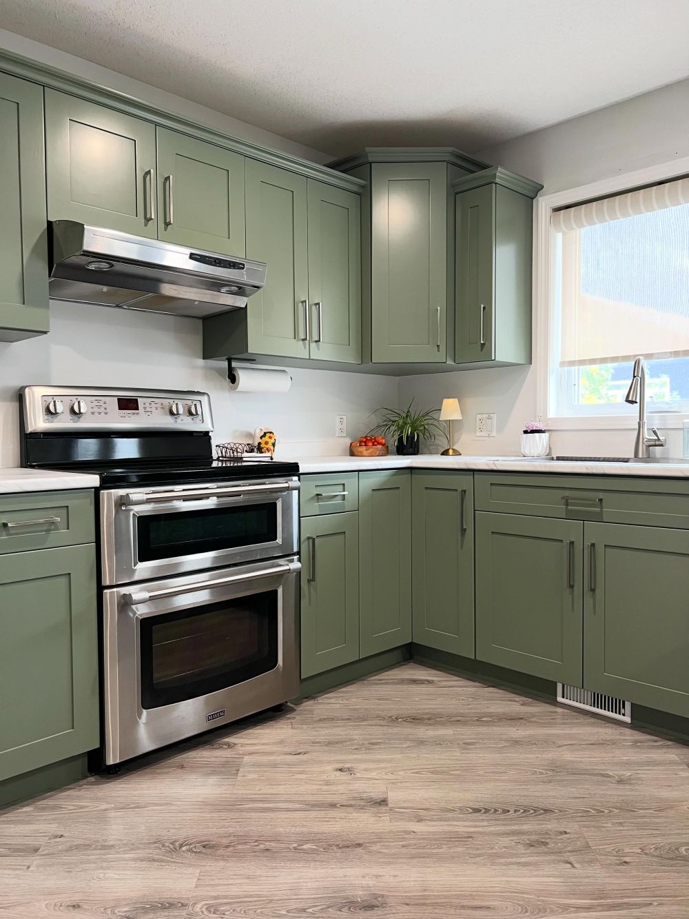 The upper cabinets extend toward the window