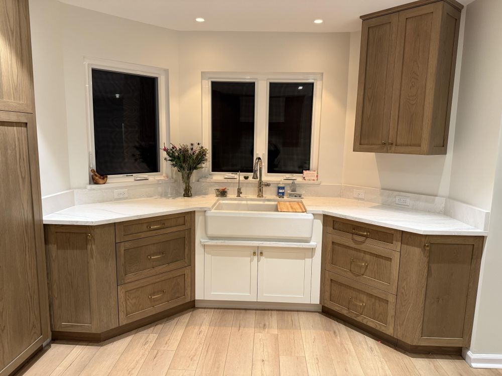 The white cabinet beneath the sink contrasts