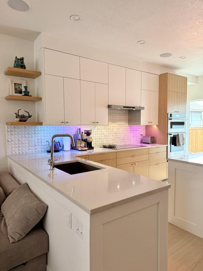 White Upper Cabinets and Oak Drawers Define the Cooking Wall