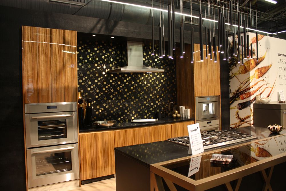Wood Cabinets With Black Stone and Exposed Brick