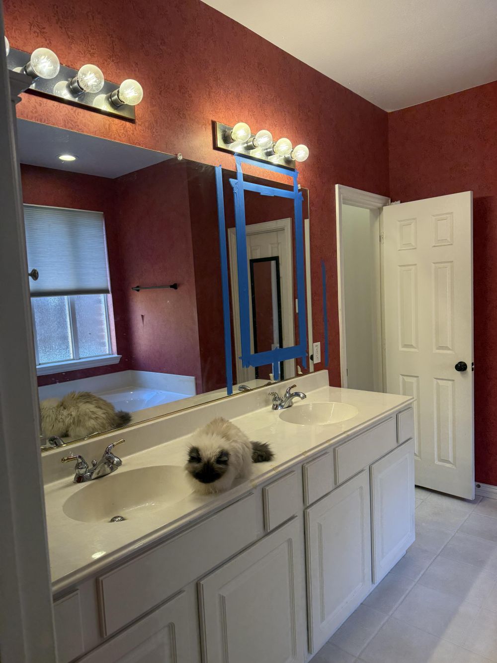 a long white vanity had two oval sinks