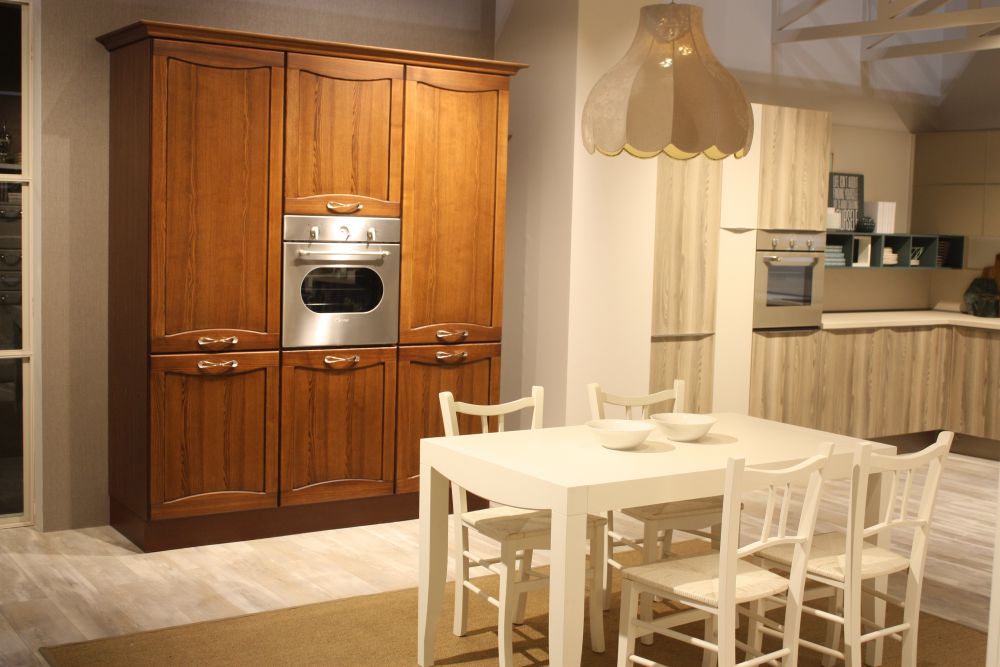 freestanding-style wood cabinet houses a built-in oven between paneled doors.