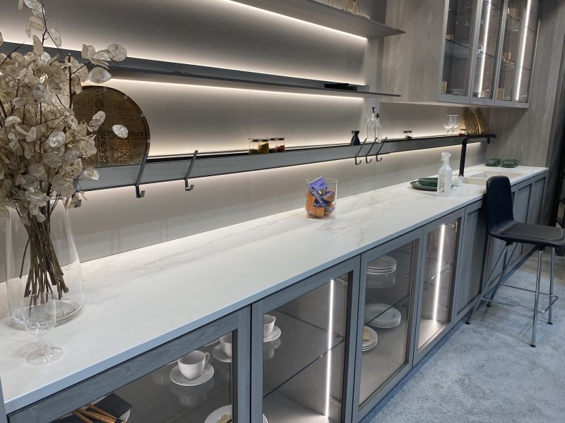 long counter uses glass-front base cabinets for cups,