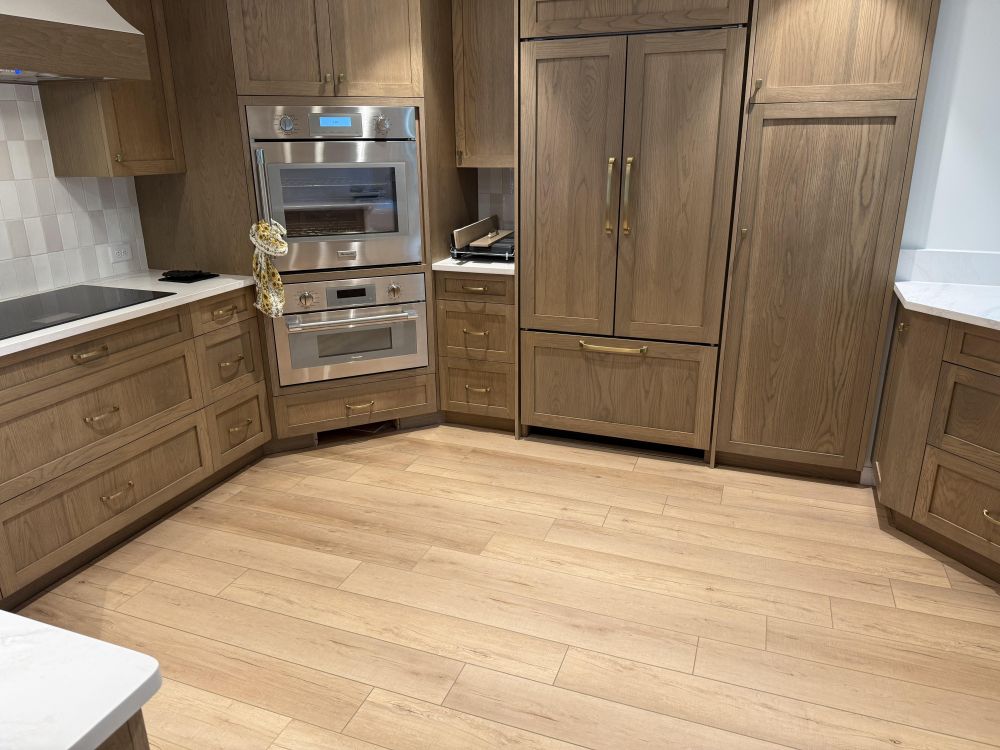 refrigerator now sits behind matching wood panels,