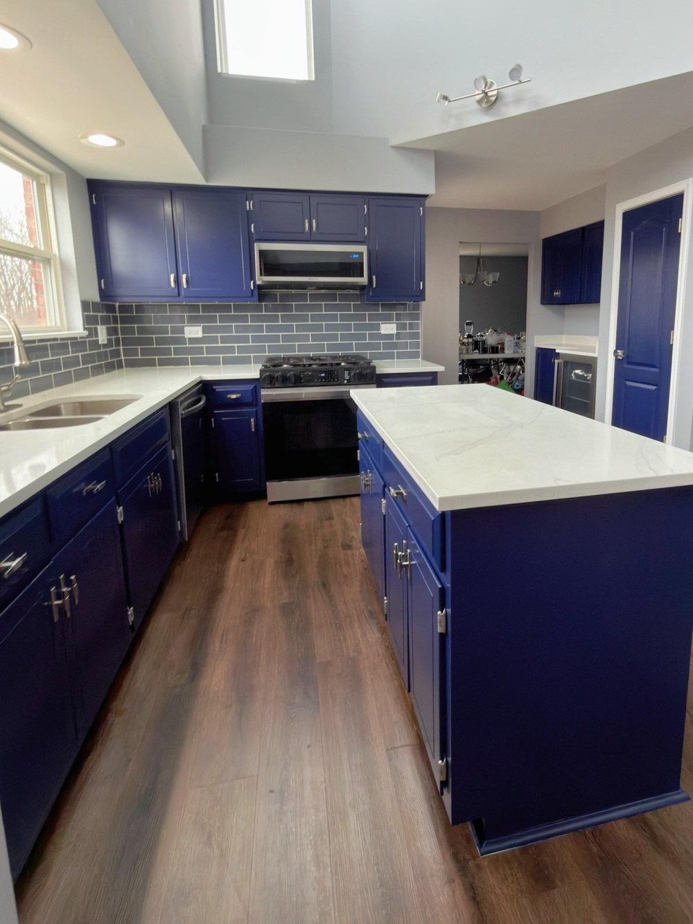 the blue island sits between the sink and cooking area