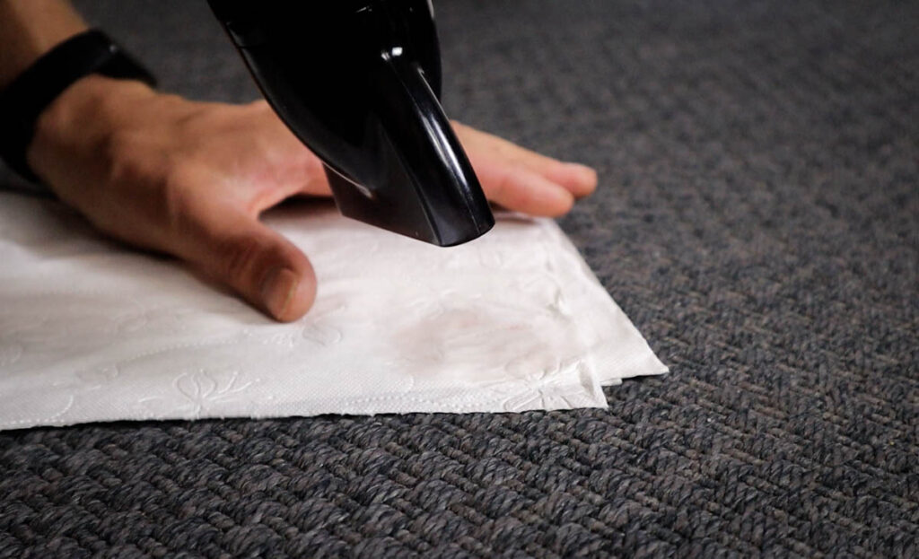 Removing candle wax from carpet with a blow dryer